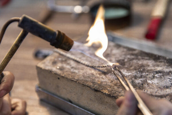 making jewelry on a high heat. High quality photo